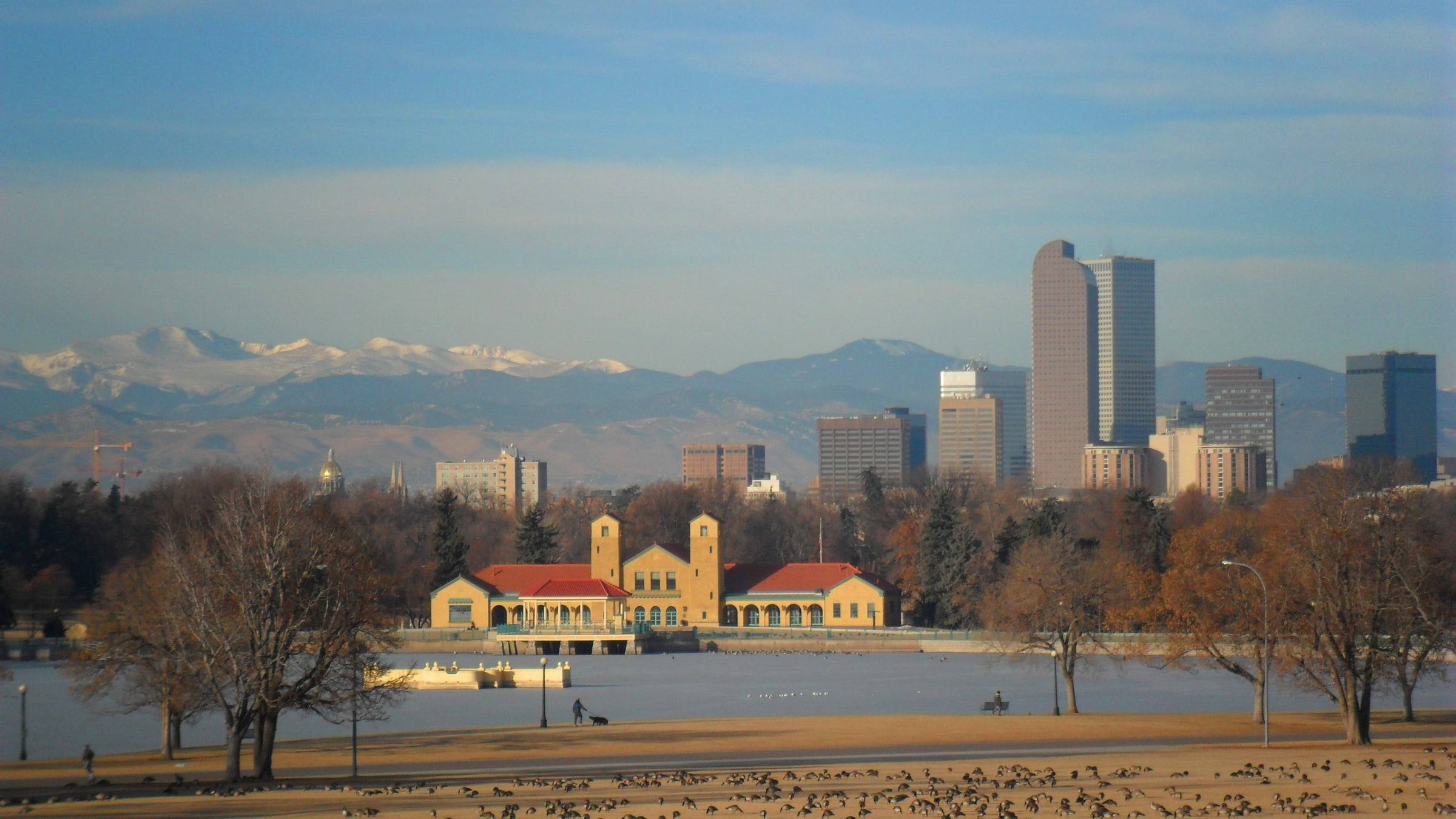 The City Park boathouse with downtown Denver and the mountains behind